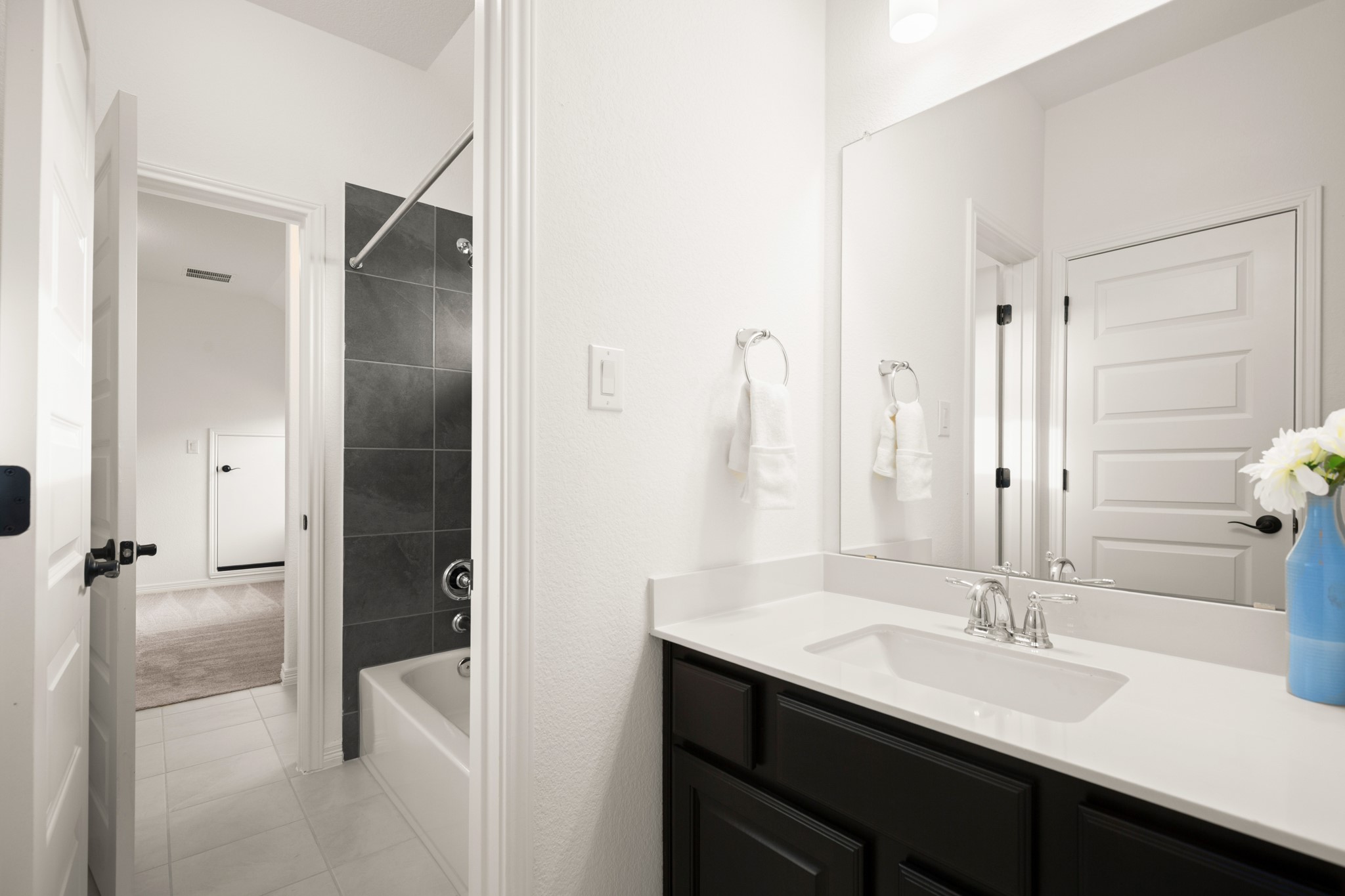 20521 Martin Lane Pflugerville, TX 78660 - Photo 27 of 40 The other bedroom's private vanity area connects to the shared wet room with the shower/tub combo and toilet.