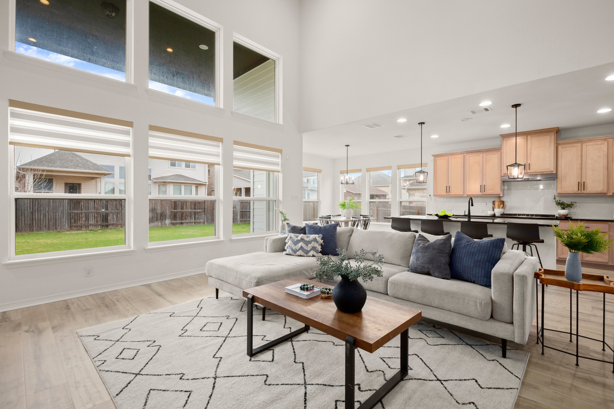 A wall of stacked windows infuses the main living area and second floor in natural light framing peaceful views of your private backyard.