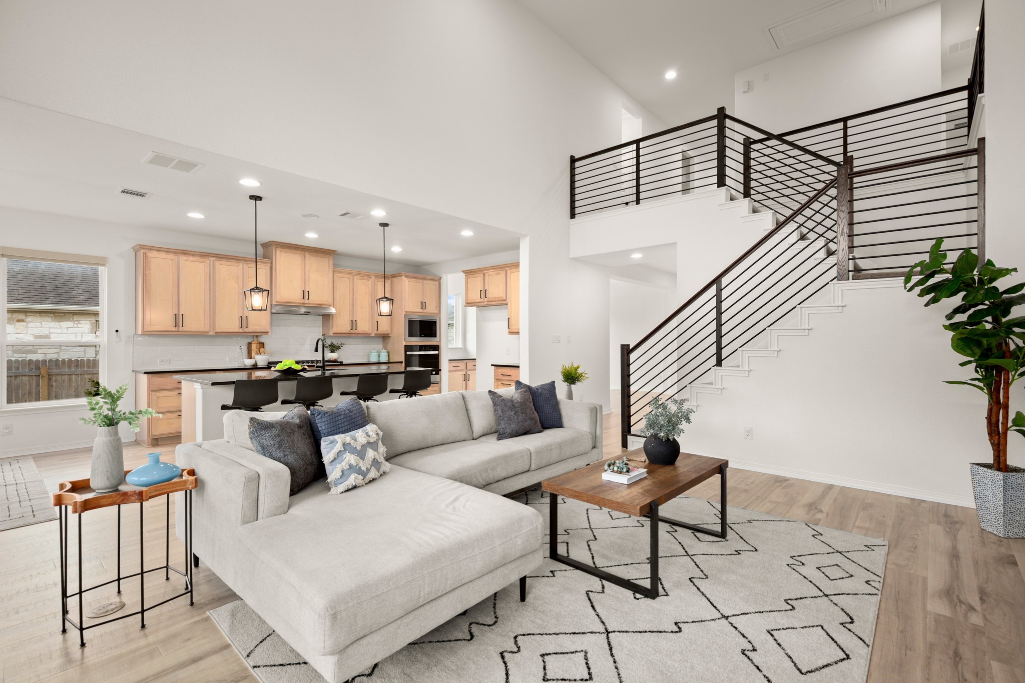 20521 Martin Lane Pflugerville, TX 78660 - Photo 8 of 40 Enjoy seamless connectivity throughout with the living room flowing into the kitchen and dining area and the second floor opening to the main level.