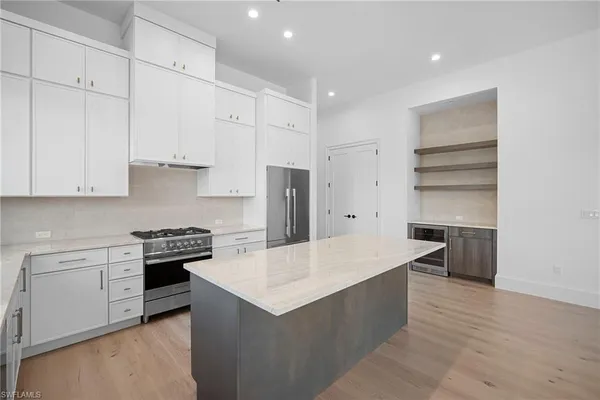 a kitchen with stainless steel appliances a stove and a refrigerator