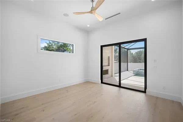 an empty room with an entryway and chandelier