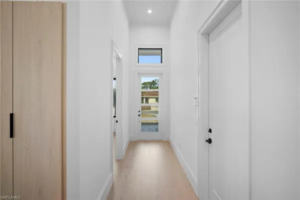 wooden floor with closet and mirror of bathroom