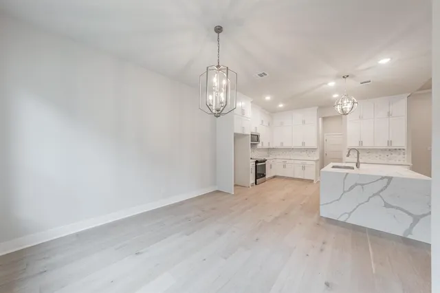 an empty room with closet and windows