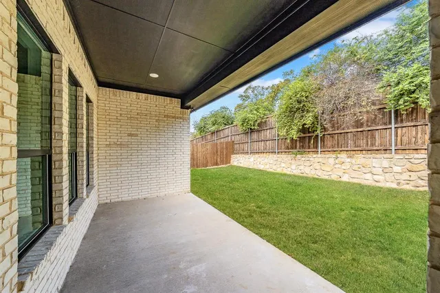 a view of kitchen with refrigerator and window