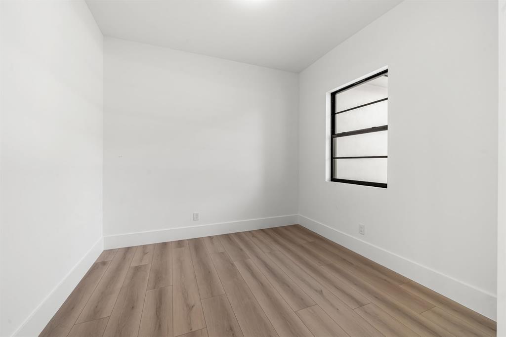 18851 42nd Road North Loxahatchee, FL 33470 - Photo 19 of 22 an empty room with a white cabinet and a window