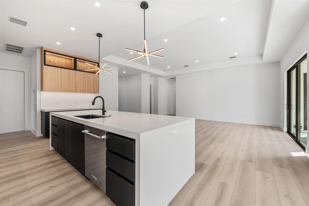 18851 42nd Road North Loxahatchee, FL 33470 - Photo 8 of 22 a kitchen with stainless steel appliances granite countertop a sink and a wooden floor