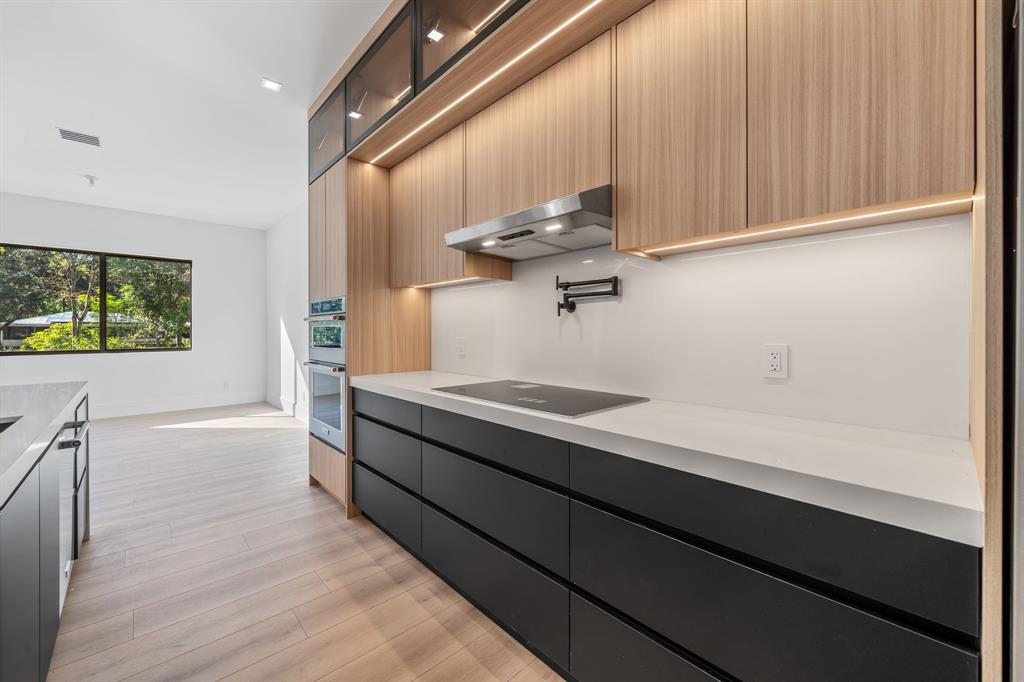 18851 42nd Road North Loxahatchee, FL 33470 - Photo 9 of 22 a kitchen with stainless steel appliances a sink dishwasher and wooden floor