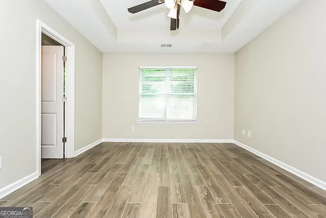 wooden floor in an empty room with a window