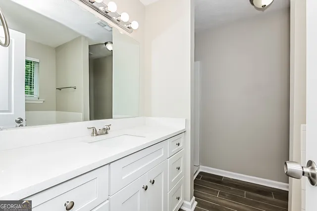 a bathroom with a sink and a mirror