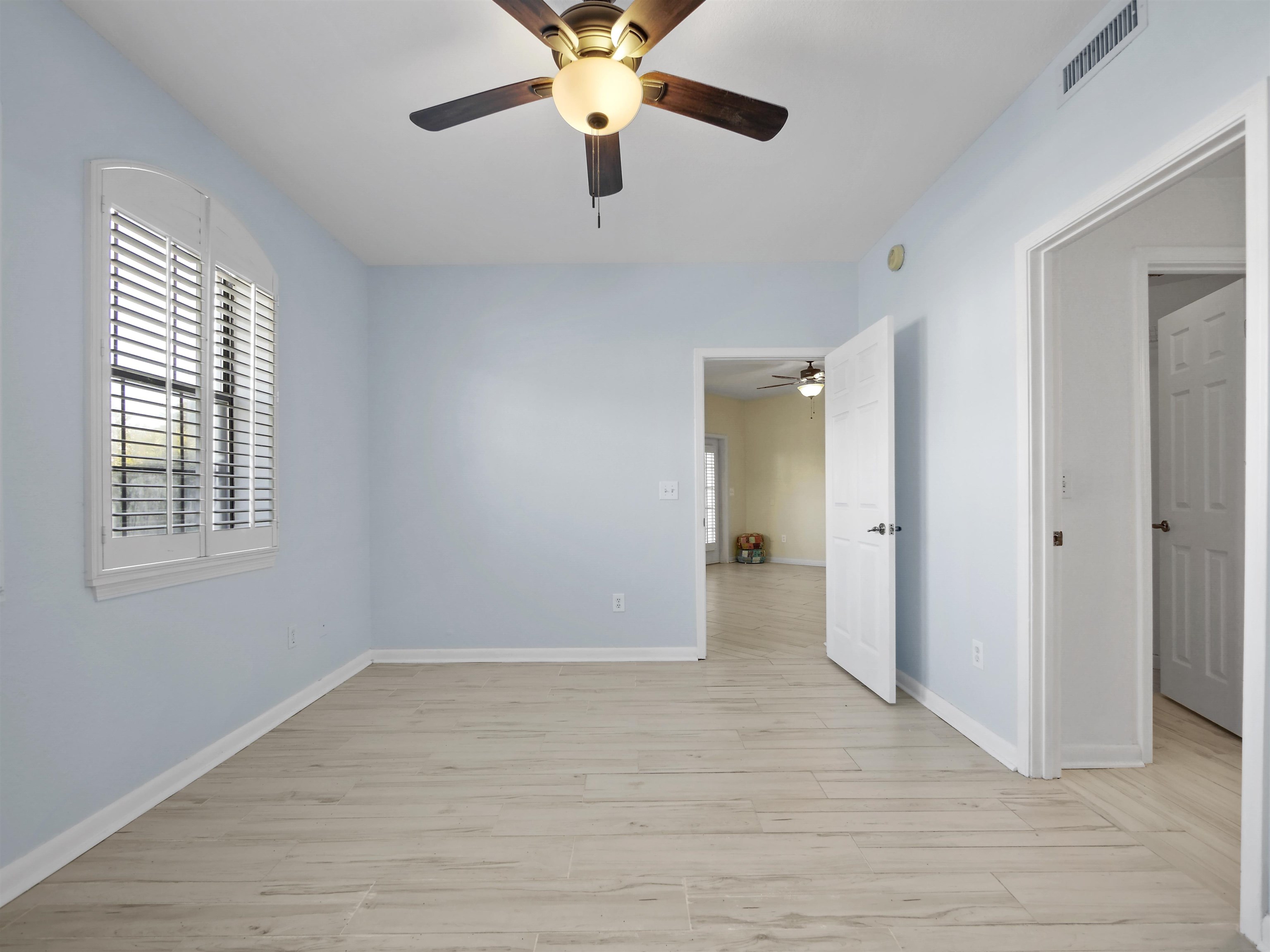 2200 Vista Cove Road St. Augustine, FL 32084 - Photo 16 of 44 a view of an empty room with window and wooden floor