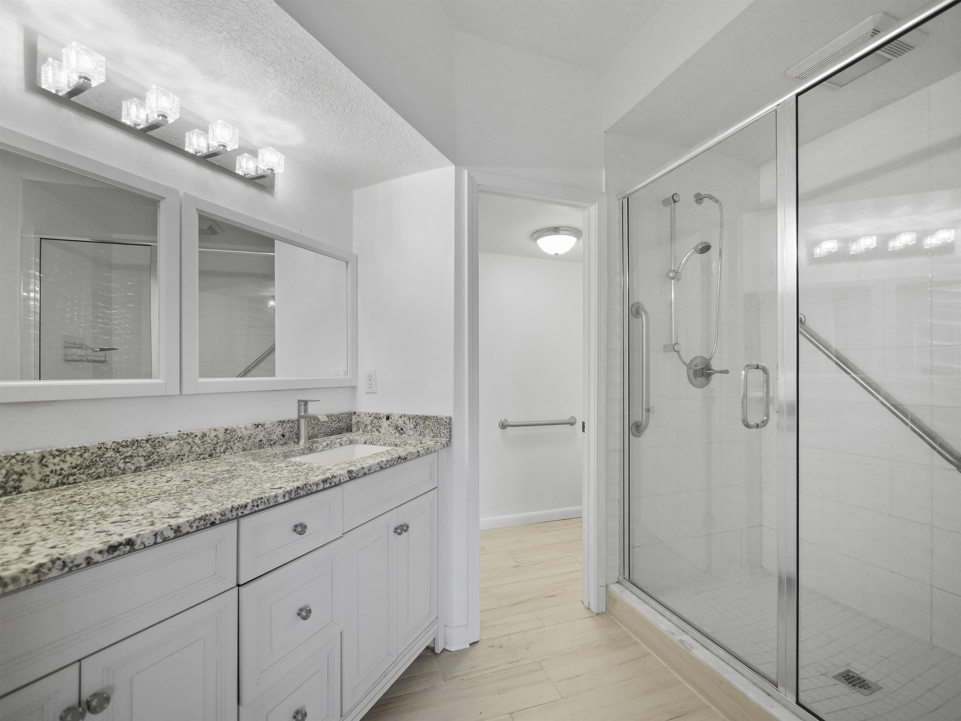 2200 Vista Cove Road St. Augustine, FL 32084 - Photo 17 of 44 a bathroom with a granite countertop sink mirror and shower