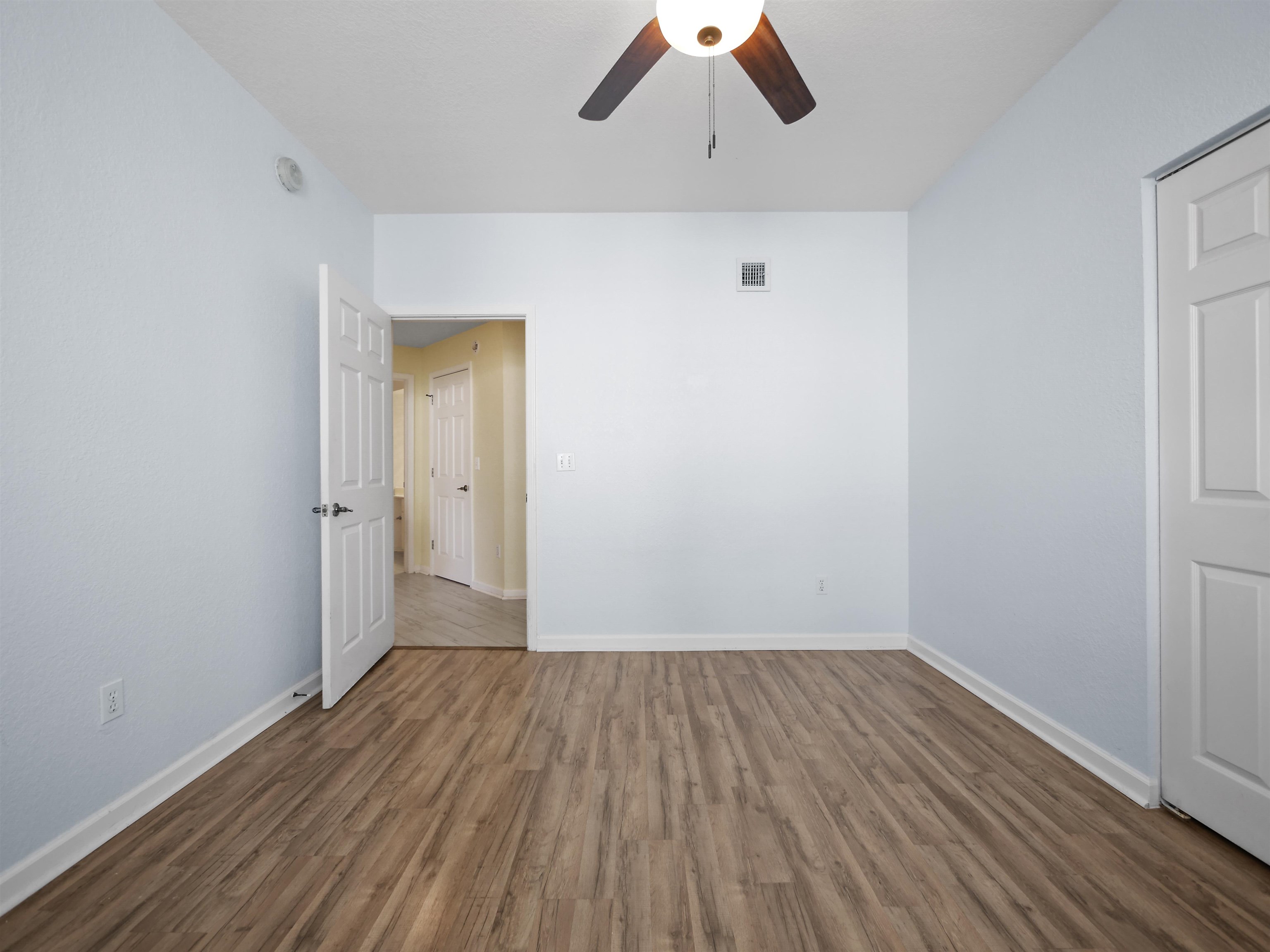 2200 Vista Cove Road St. Augustine, FL 32084 - Photo 21 of 44 a view of a room with wooden floor a ceiling fan and window