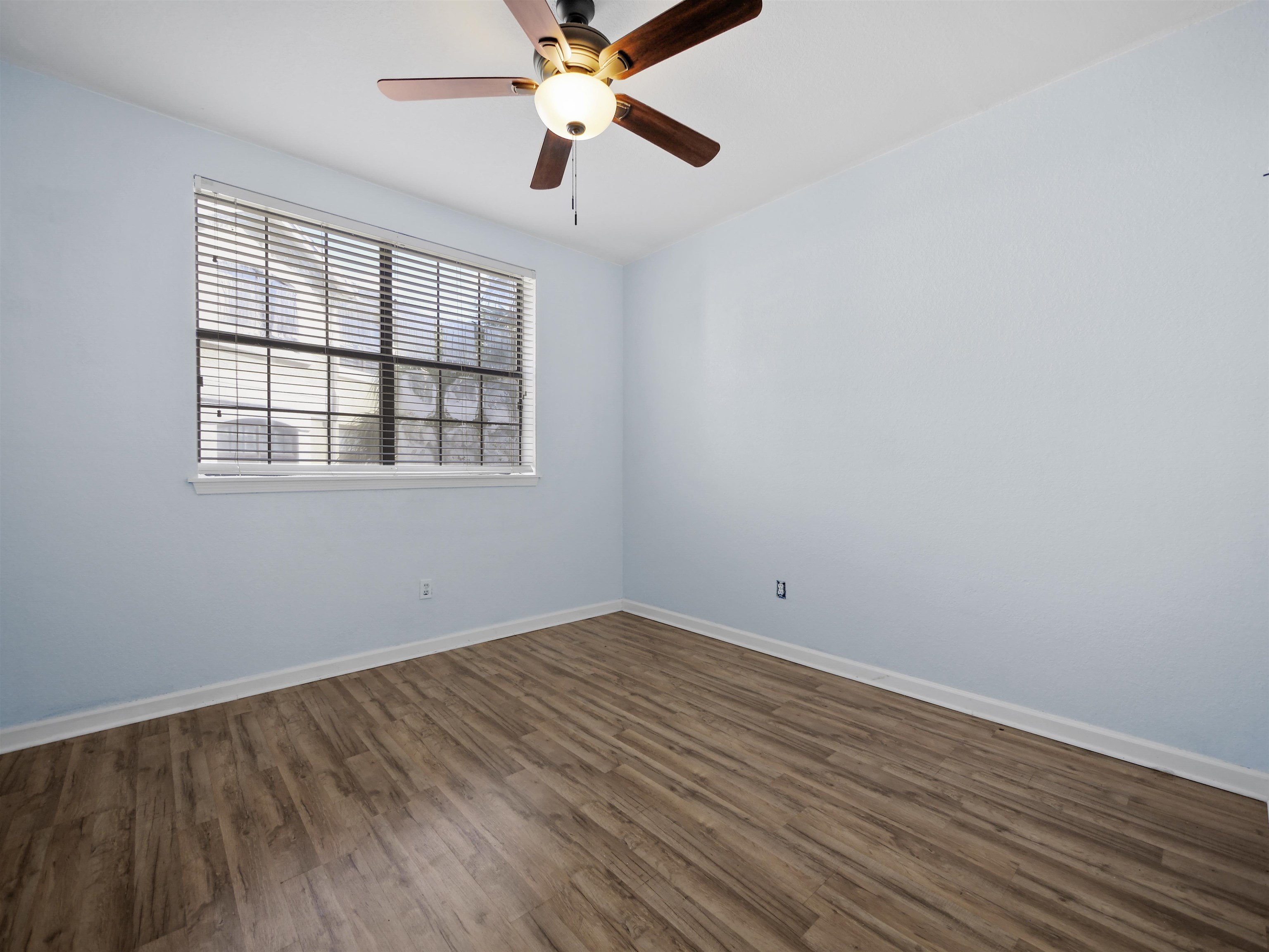 2200 Vista Cove Road St. Augustine, FL 32084 - Photo 24 of 44 an empty room with wooden floor fan and windows