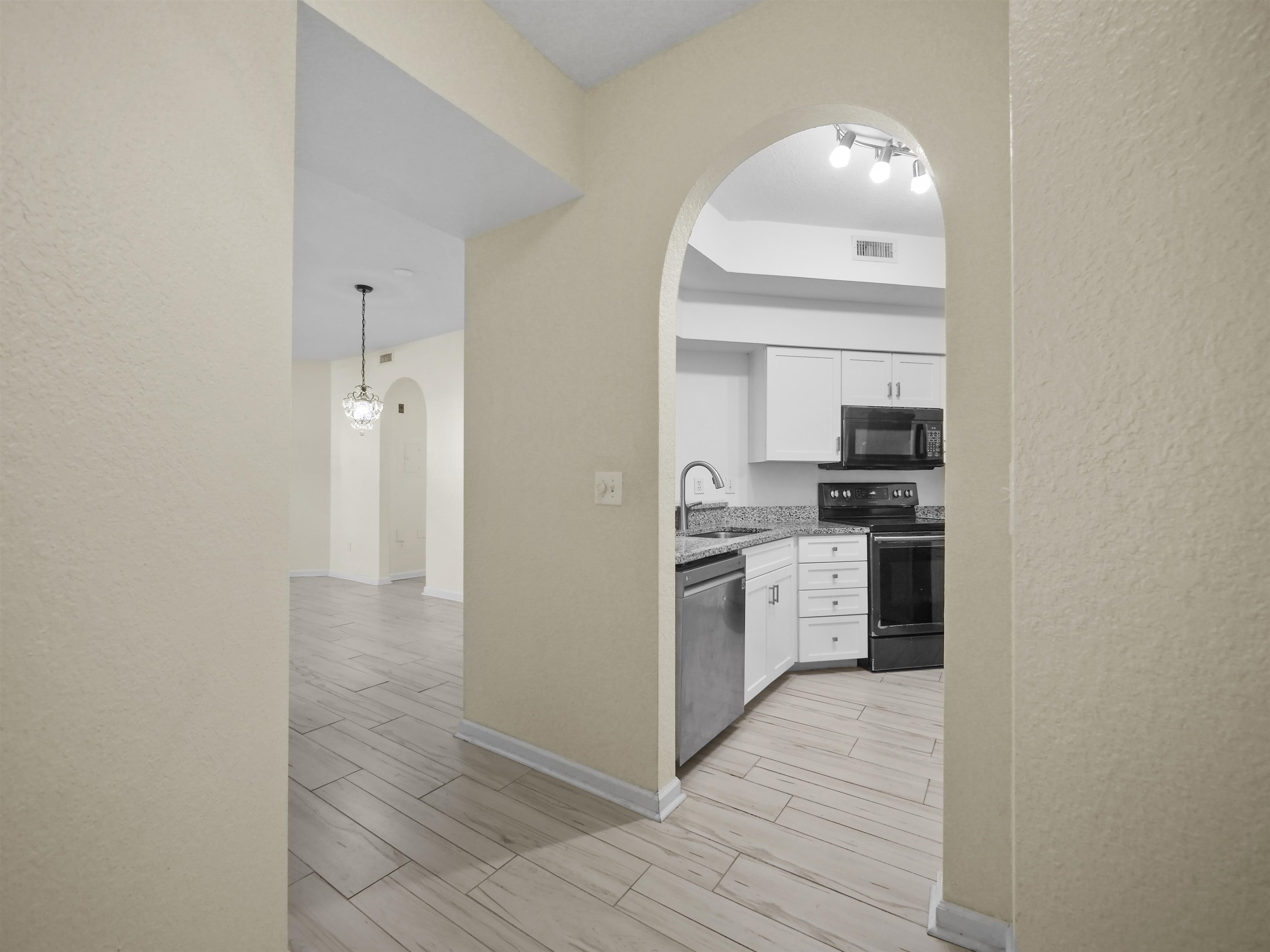 2200 Vista Cove Road St. Augustine, FL 32084 - Photo 3 of 44 a kitchen with granite countertop a stove and a refrigerator
