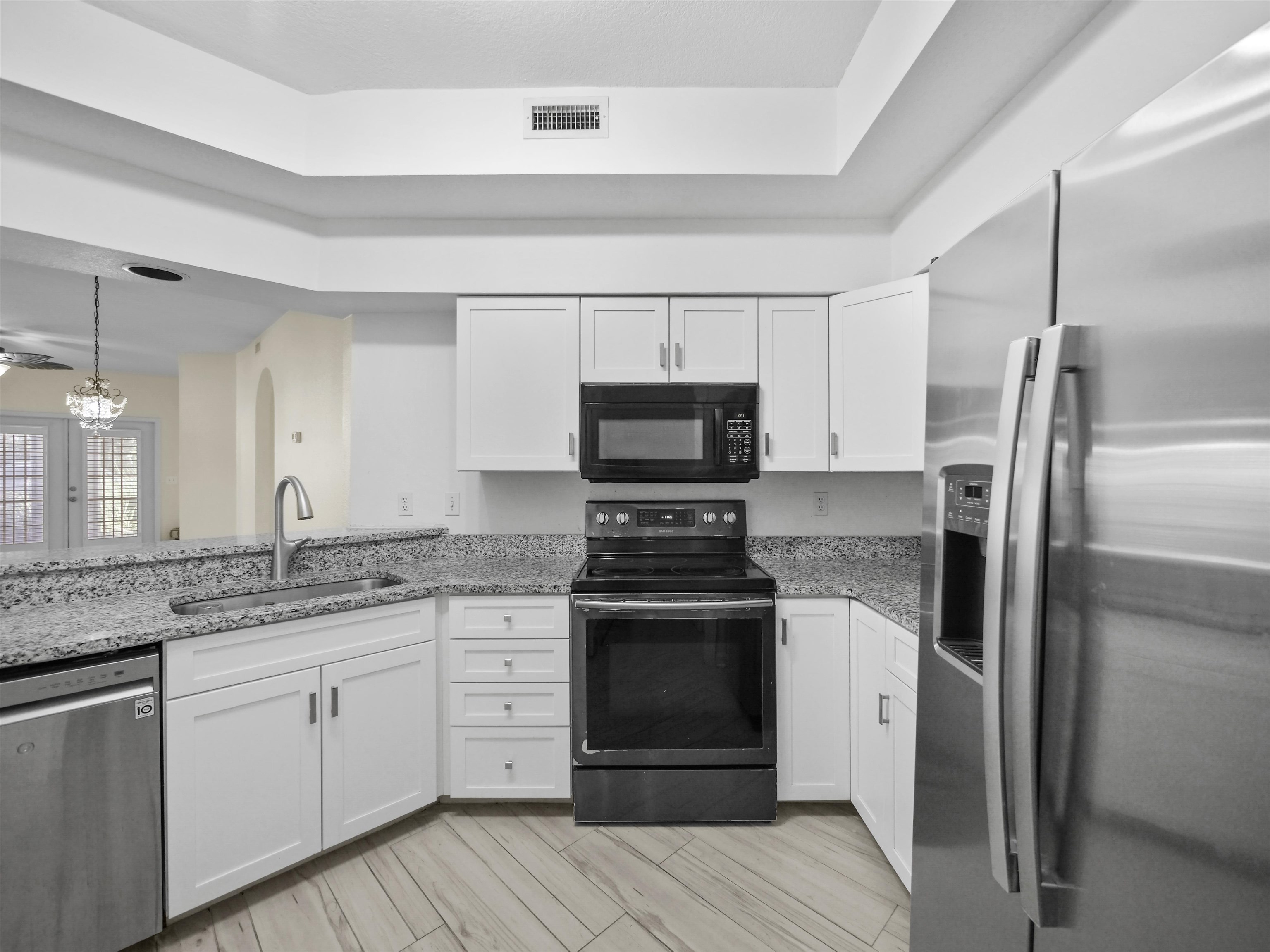 2200 Vista Cove Road St. Augustine, FL 32084 - Photo 5 of 44 a kitchen with a sink stove and refrigerator
