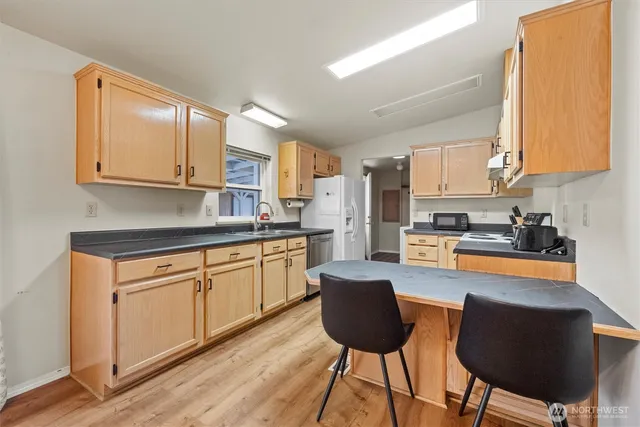 a kitchen with stainless steel appliances granite countertop a stove a sink dishwasher a microwave oven with granite countertops and cabinets