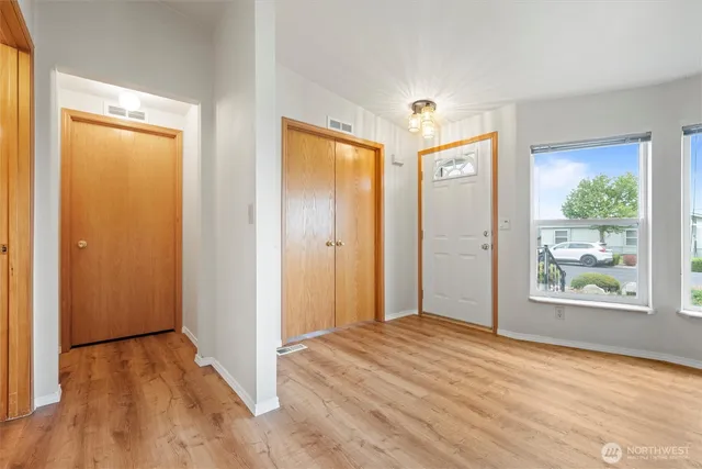 a view of a bedroom with wooden floor and doors