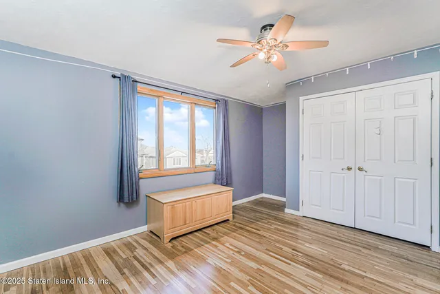 a spacious bedroom with a bed and a window