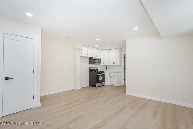 a view of a kitchen with a sink and a refrigerator