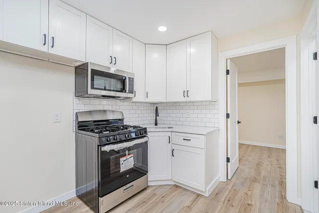 a kitchen with granite countertop a stove and a sink