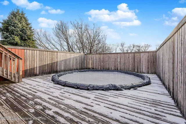a view of a house with wooden fence