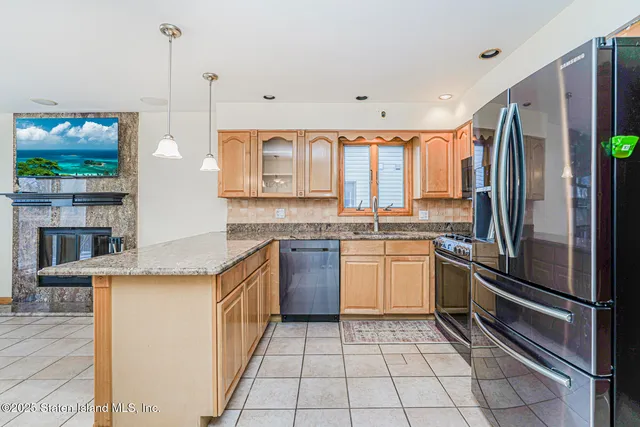 a kitchen with a refrigerator a oven a sink and a window