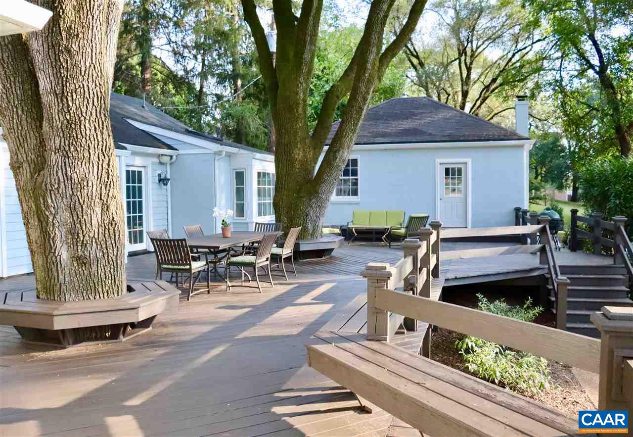 16 Canterbury Road Charlottesville, VA 22903 - Photo 5 of 37 a view of a patio with table and chairs and a barbeque with wooden fence and trees