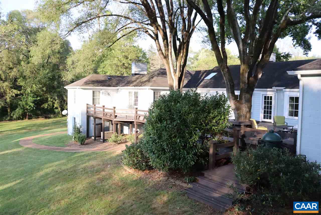 16 Canterbury Road Charlottesville, VA 22903 - Photo 7 of 37 a view of a patio with table and chairs and potted plants with large trees