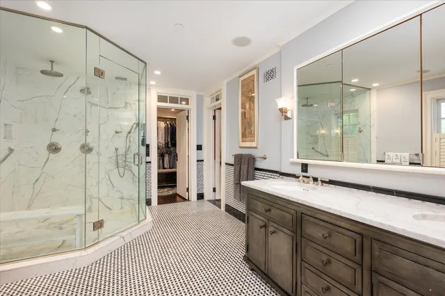 a spacious bathroom with a shower sink and mirror