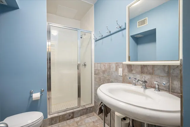 a bathroom with a sink toilet and shower