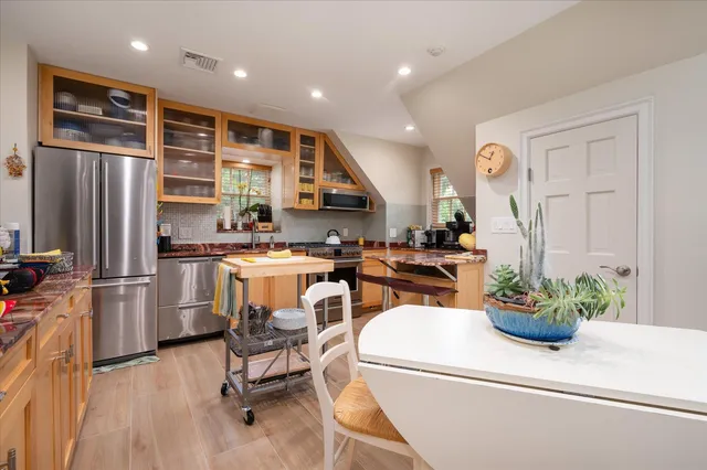 a kitchen with a refrigerator and a table