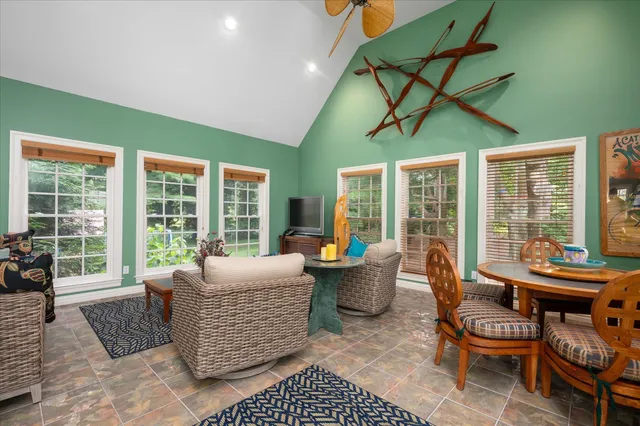 a living room with furniture and large windows