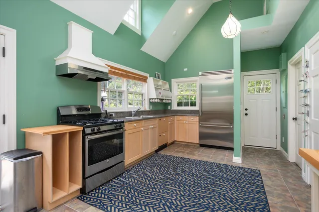 a kitchen with stainless steel appliances a stove a refrigerator and cabinets