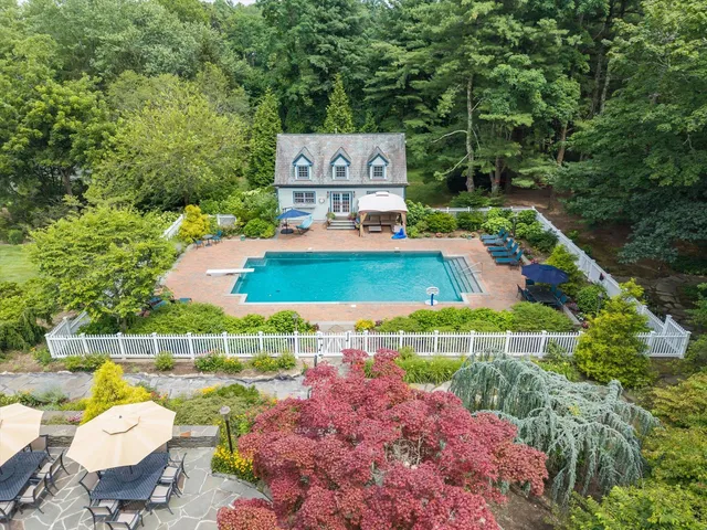 a view of a chairs and table in backyard