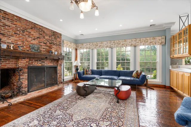 a living room with furniture windows and a fireplace