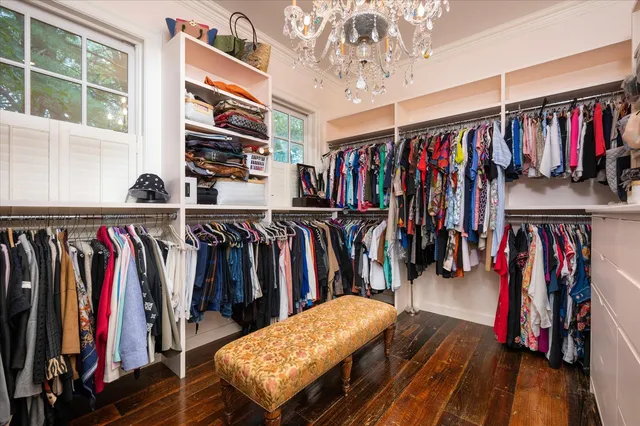 a view of walk in closet with clothes and shoes