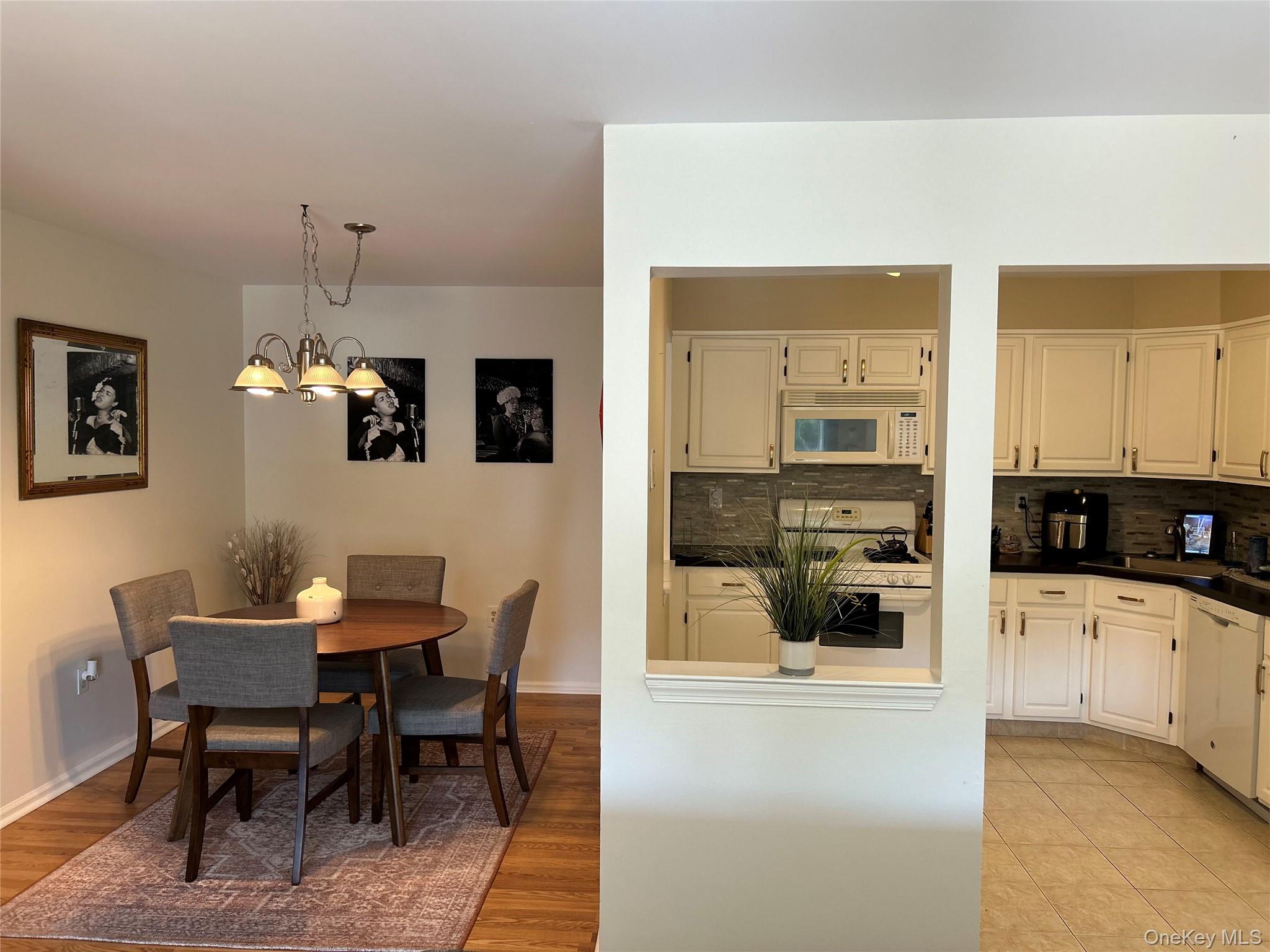 9 Edinburgh Drive, Unit 9 Peekskill, NY 10566 - Photo 1 of 1 a kitchen with granite countertop a table and chairs in it