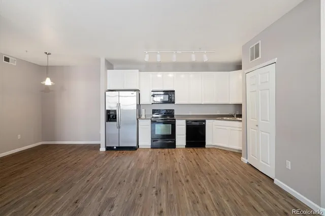a kitchen with stainless steel appliances granite countertop a stove and a refrigerator