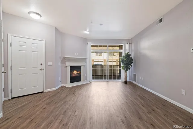 a kitchen with wooden floors and a fireplace