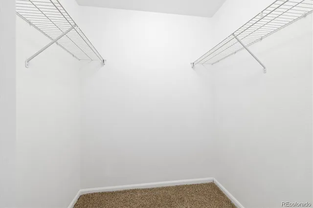 an empty room with wooden floor and a window