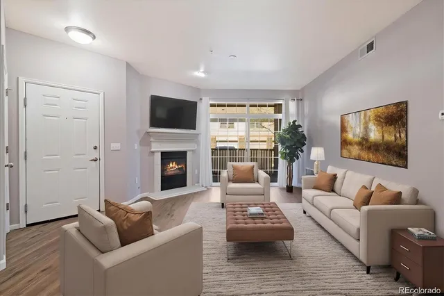 a living room with furniture fireplace and a flat screen tv