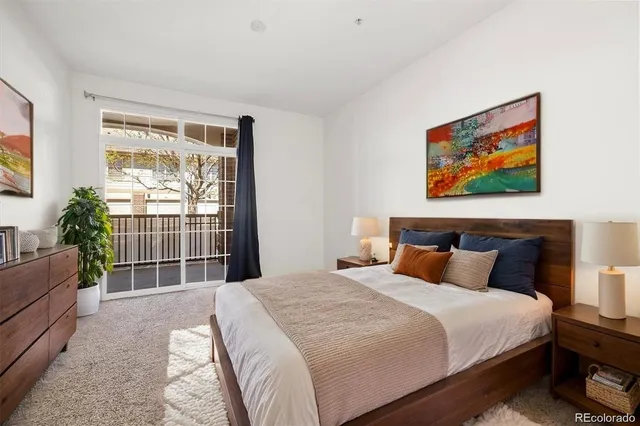 a bedroom with bed and wooden floor