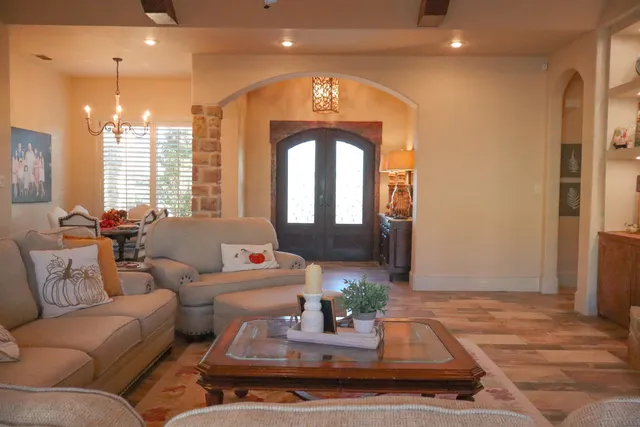 a living room with furniture a flat screen tv and a fireplace