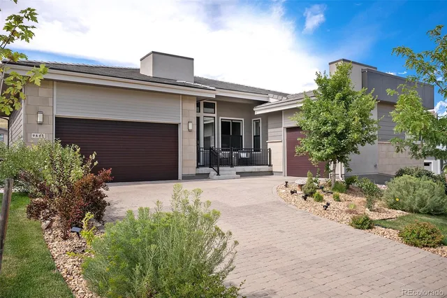 front view of a house with potted plants