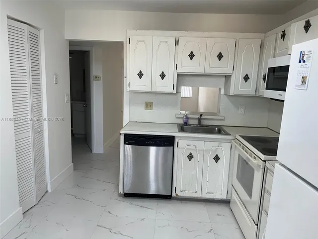 a kitchen with stainless steel appliances granite countertop a sink and a stove