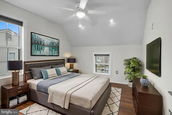 a bedroom with a large bed and a flat screen tv