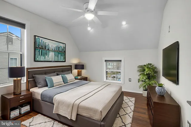 a bedroom with a large bed and a flat screen tv