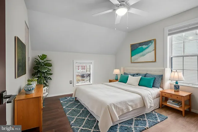 a bedroom with a bed and a potted plant