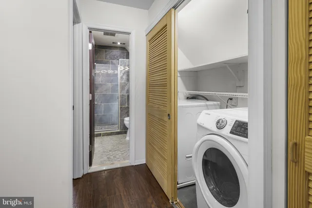 a view of a hallway with washer and dryer