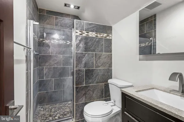 a white toilet sitting next to a bathroom sink